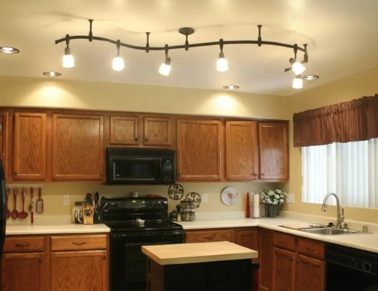 Kitchen with new track lighting and warmer illumination