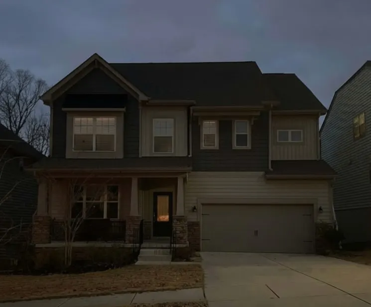 Two-story house at dusk with lights off