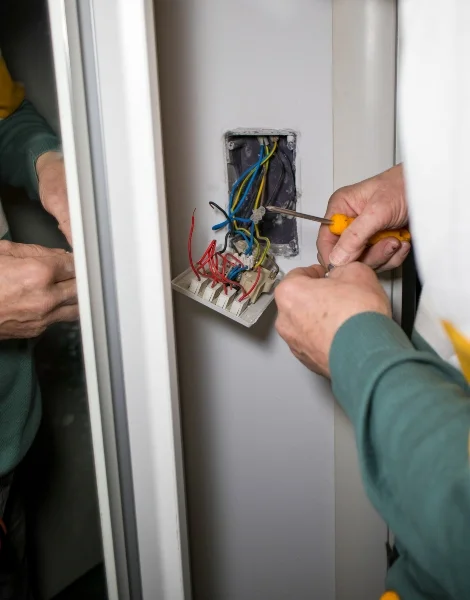 Worker repairing wall socket wiring